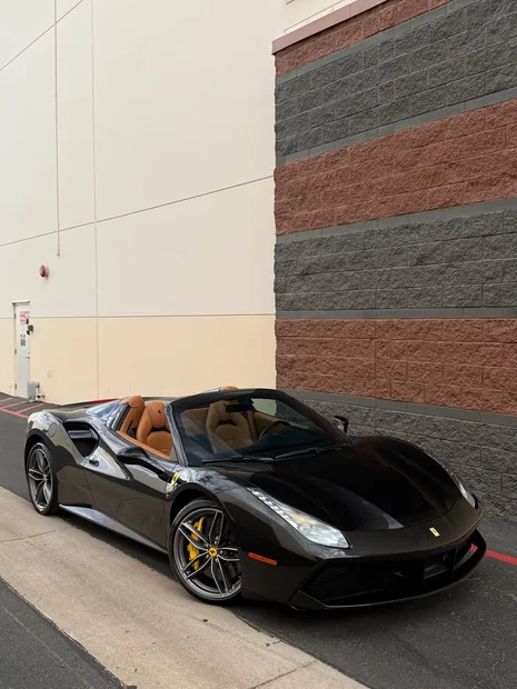Black Ferrari 488 Spider with tan interior after an exterior detail